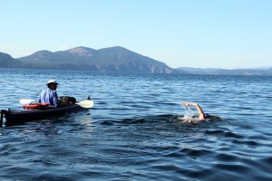 Roni Hibben swims with kayak support crew Randy Hixon. Photo by Ben Olson.