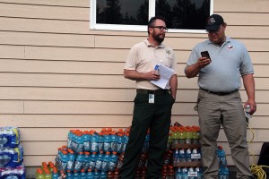 Officials stand before a stack of supplies at the meeting Tuesday night. Photo by Ben Olson.