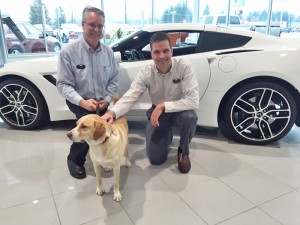 Jeff Doughty, left, service manager, and Brett Taylor, right, general manager pose with Drake (he’s the furry one). 