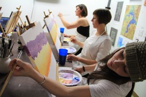 Kelsy, Courtney and Molly paint during Kris Dills' class at Infini Gallery. Photo by Ben Olson.