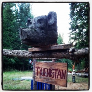 A carved bear head and totem pole–courtesy of the dump–guard the garden. Photo by Jen Jackson Quintano.