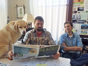 Drake, left, proofreads his latest column with publisher Ben Olson, center, and editor Cameron Rasmusson, right.
