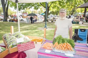 Ron Kilgore - Muskrat Hill Farm:  Years at the Farmers Market: six      “Sales have been increasing every year since we started. Every year is different. This year we had to deal with the aftermath of a very mild winter with unusually warm temperatures very early in the spring followed by a return to colder weather. The mild winter meant no winter kill for a lot of pests. They survived and were hungry and ready to go when things warmed up. The hot-cold cycle also caused early bolting in a lot of our crops.” Photo by Cameron Barnes