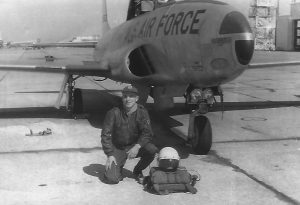 Jim Ramsey kneels before his  T-33 jet trainer in this photograph taken in 1957 at Bryan A.F.B, Texas. Courtesy photo.