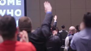 Attendants at the National Policy Institute’s annual conference give Nazi salutes as NPI head Richard Spencer praises president-elect Donald Trump. YouTube screenshot. 