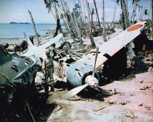 A soldier stands next to a downed Mitsubishi Zero fighter on the Soloman Islands in 1943. Courtesy photo.